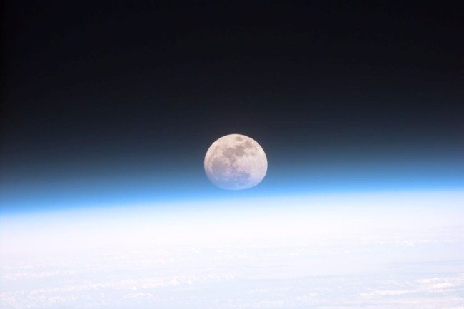 Full moon partially obscured by atmosphere